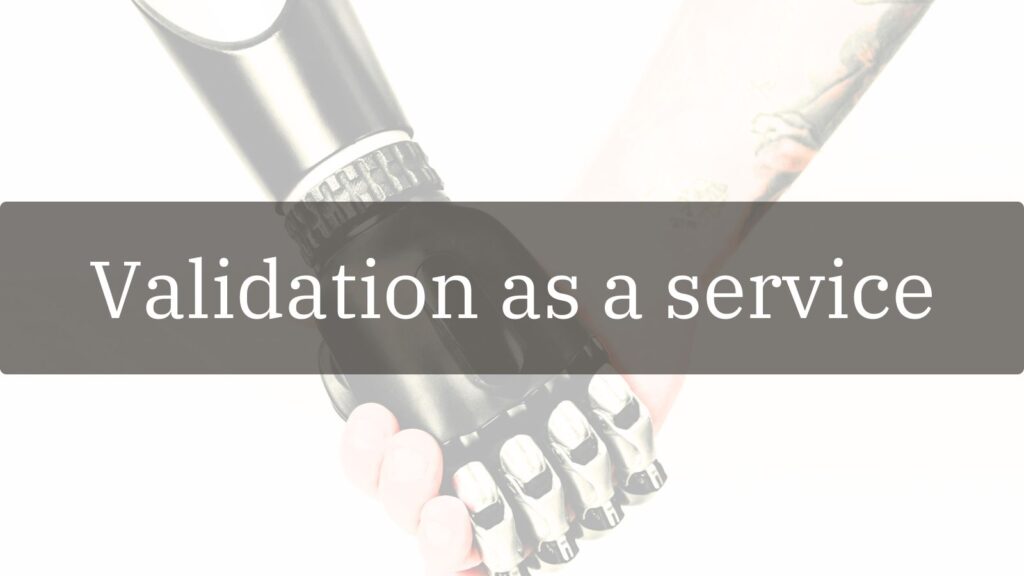 Chrome robotic hand and human hand clasping in handshake against white background with grey text overlay reading "Validation as a service"